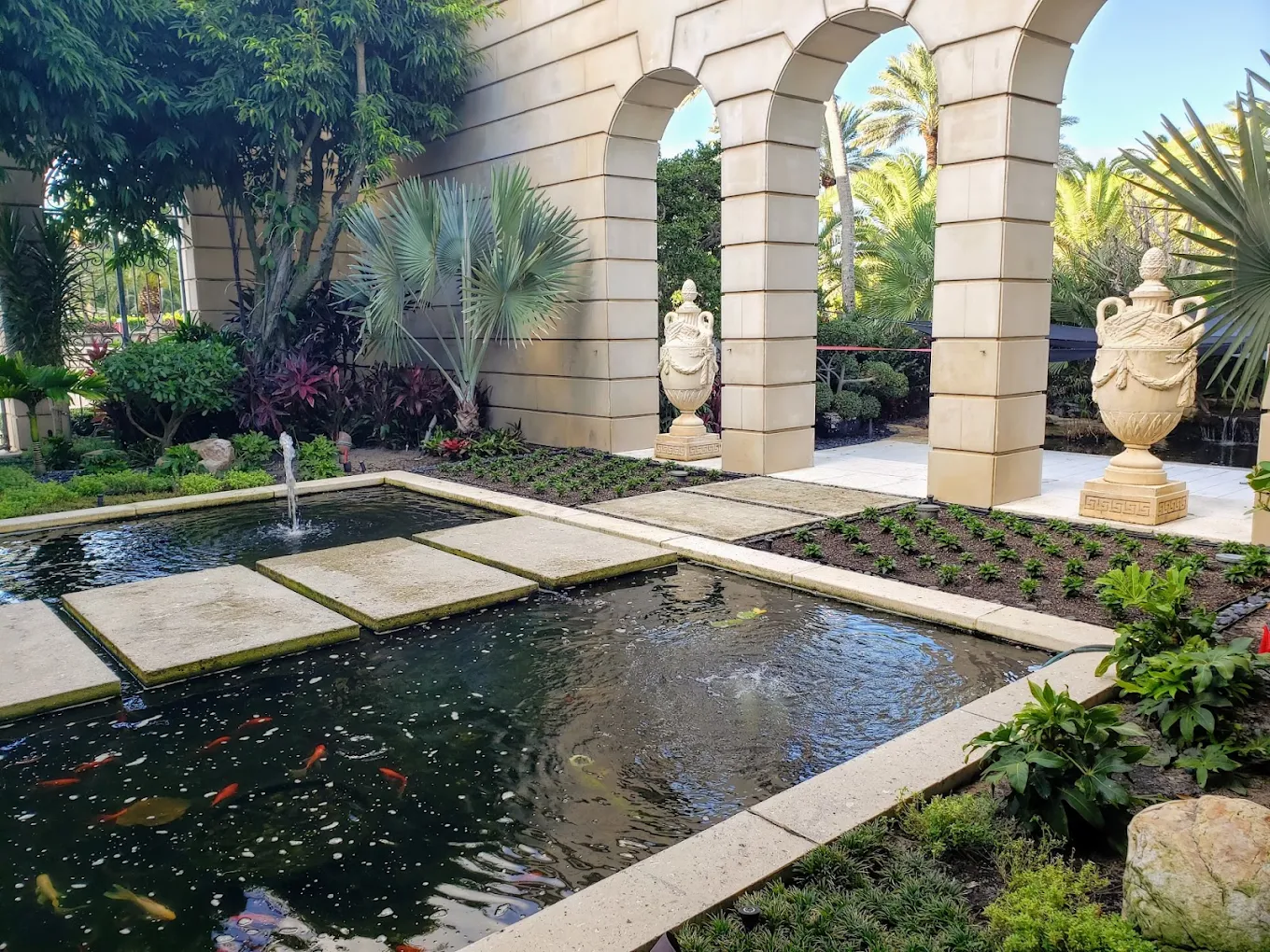 Elegant water feature with koi pond and decorative arches